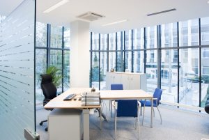 A glass-front office with modern furniture