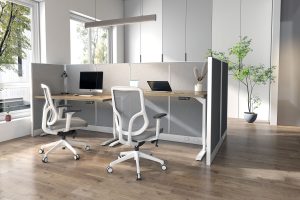 Picture of white office chairs in front of desks and cubicles.
