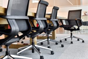 Row of office chairs along a conference table.