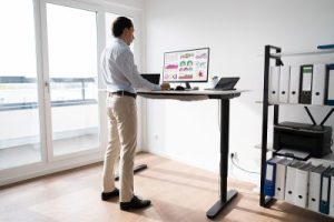 Man using computer at standing desk